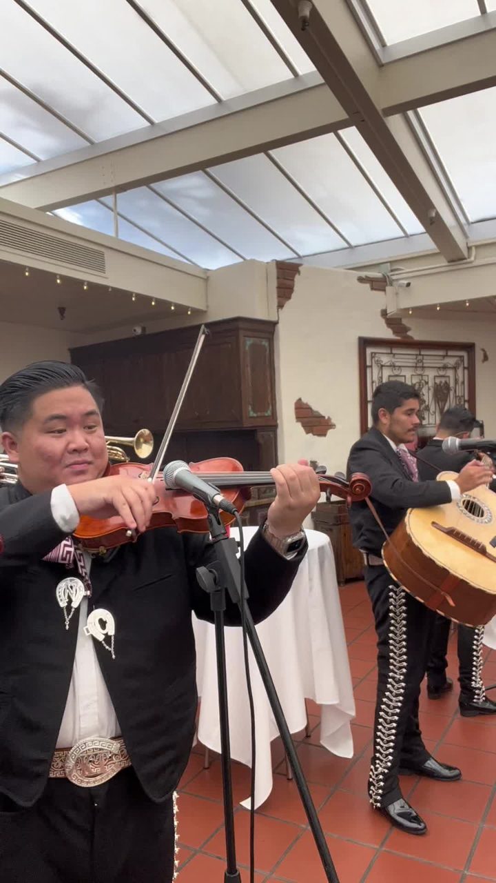 The group performing South of the Border at a mission-style wedding venue